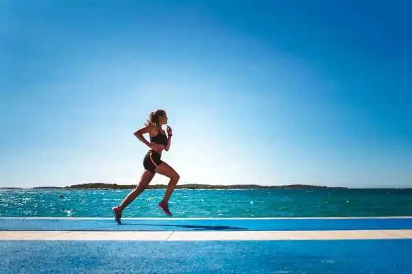 Woman running showing strong leg muscle Ilford